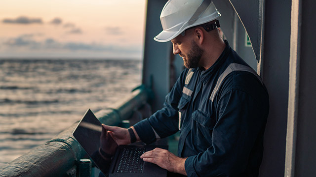Service engineer reviewing equipment data on board